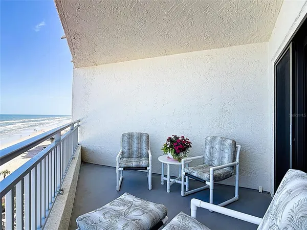 a balcony with furniture and flowers