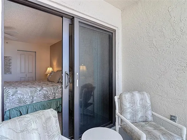 a bedroom with a large bed and a flat tv screen on dresser