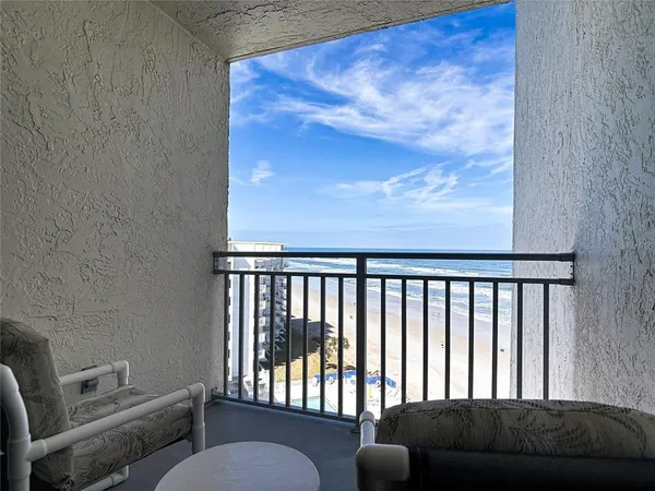 a bedroom with a bed and a flat tv screen on dresser