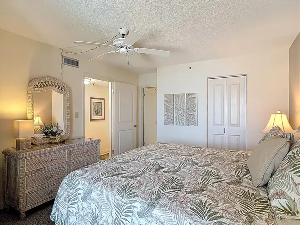 a bathroom with a granite countertop sink a mirror and shower