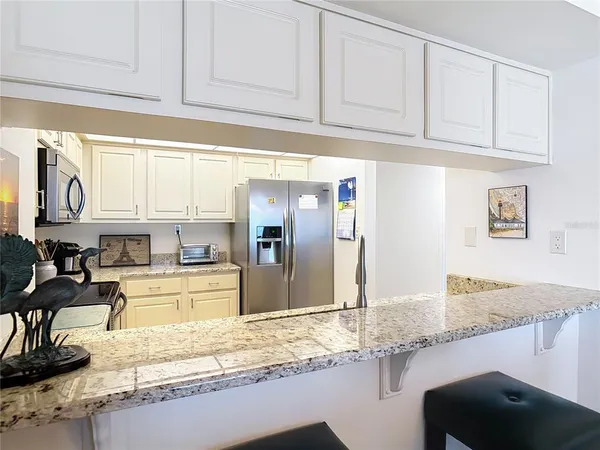 a kitchen with stainless steel appliances granite countertop a sink and cabinets