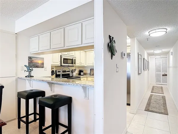 a dining room filled chandelier and wooden floor