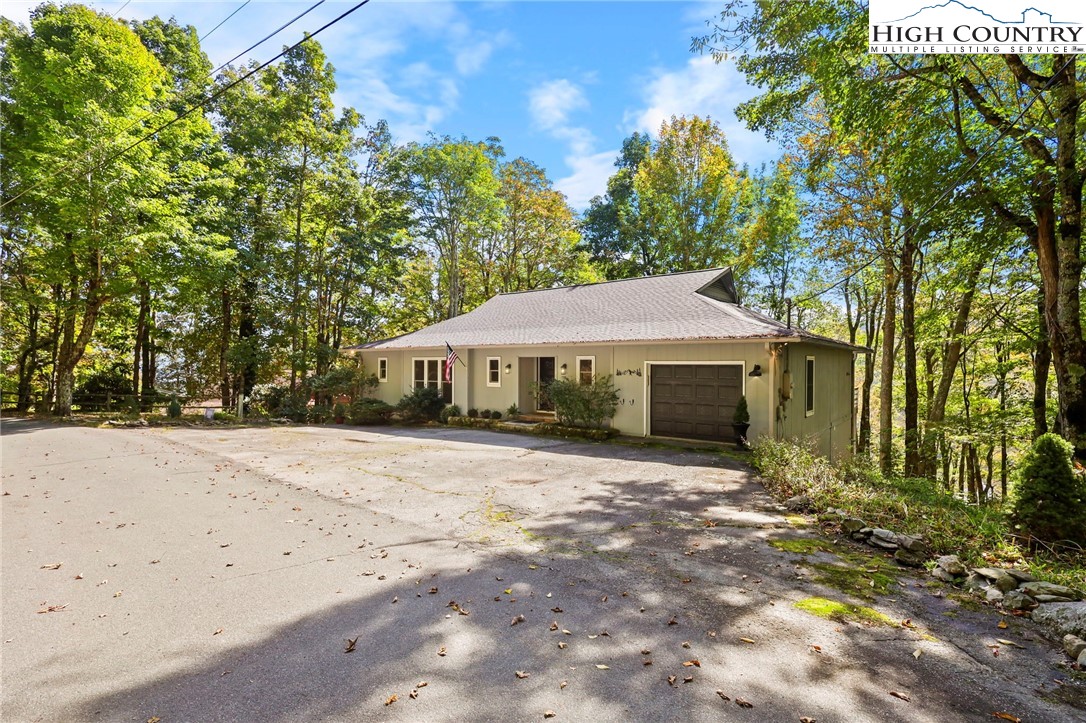 202 Cliffside Lane Seven Devils, NC 28604 - Photo 2 of 46 a front view of a house with a yard