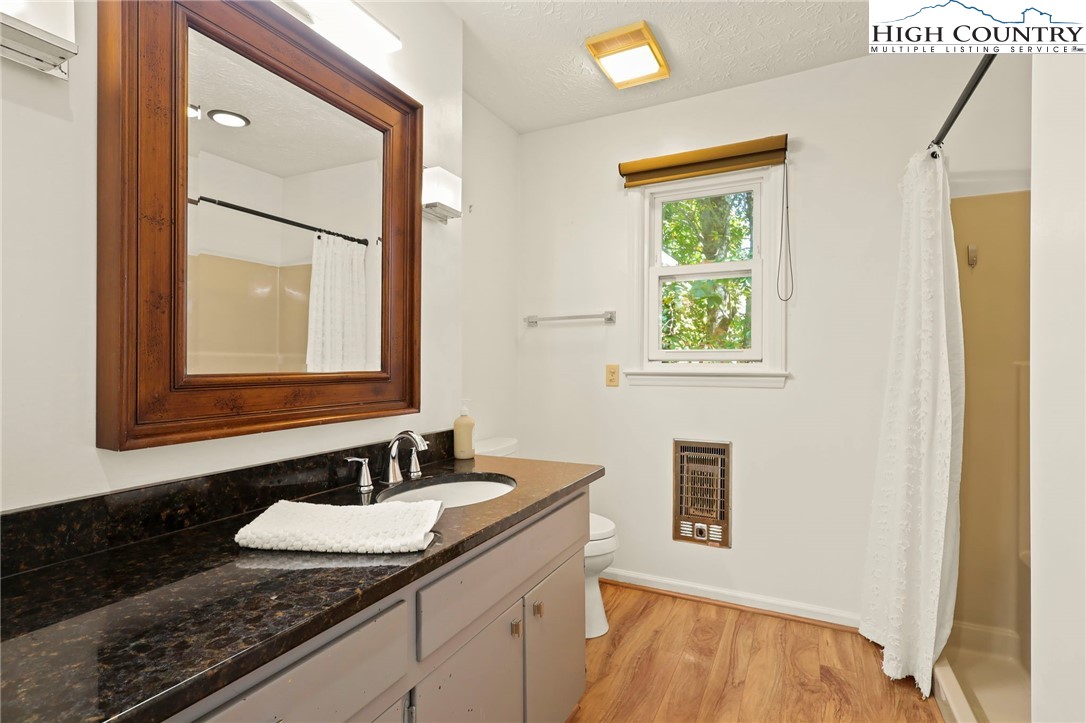 202 Cliffside Lane Seven Devils, NC 28604 - Photo 21 of 46 a bathroom with a granite countertop sink and a mirror