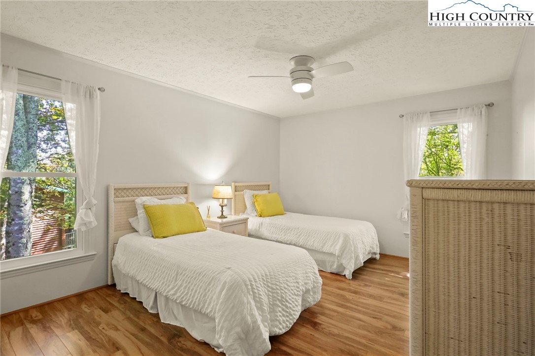 202 Cliffside Lane Seven Devils, NC 28604 - Photo 26 of 46 a bedroom with two beds and a window