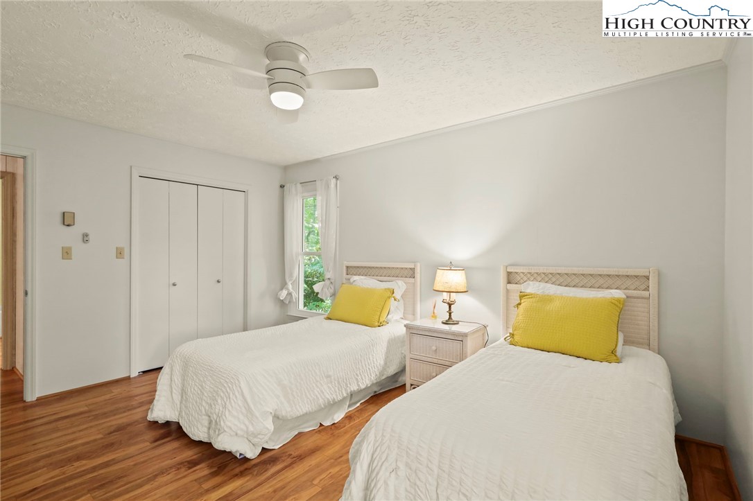 202 Cliffside Lane Seven Devils, NC 28604 - Photo 27 of 46 a bedroom with two beds and wooden floor