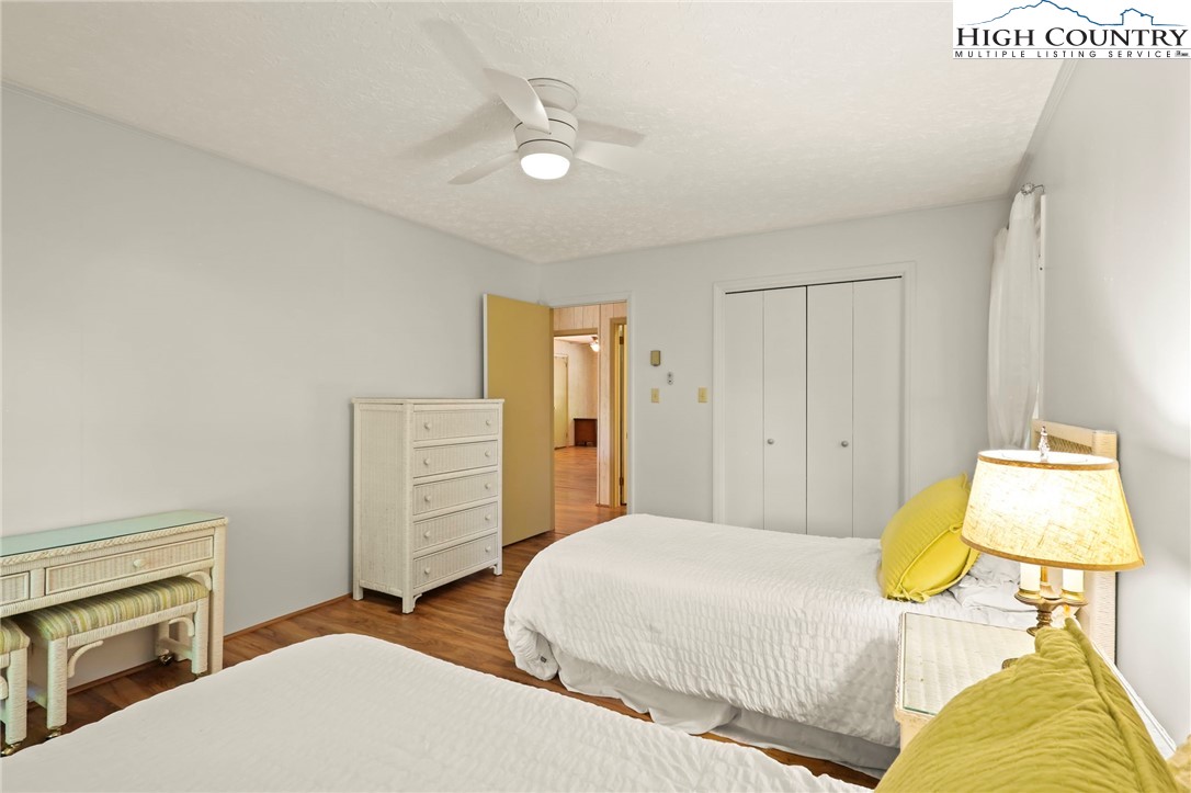 202 Cliffside Lane Seven Devils, NC 28604 - Photo 28 of 46 a bedroom with a bed and a couch