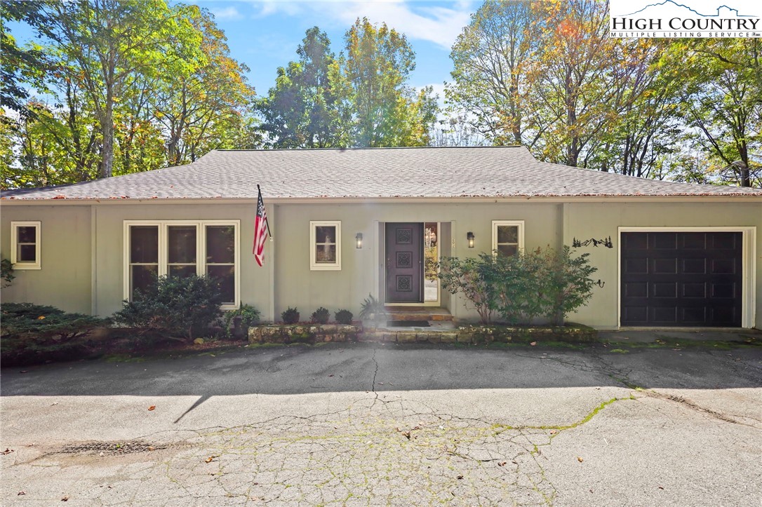 202 Cliffside Lane Seven Devils, NC 28604 - Photo 3 of 46 a front view of a house with a yard and garage