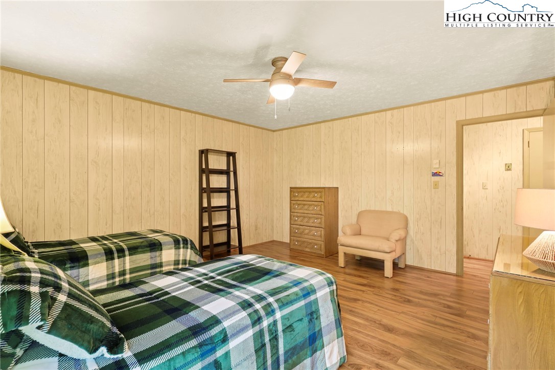 202 Cliffside Lane Seven Devils, NC 28604 - Photo 33 of 46 a bedroom with a bed and wooden floor