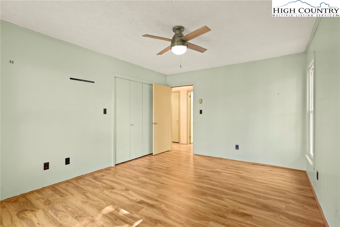 202 Cliffside Lane Seven Devils, NC 28604 - Photo 34 of 46 a view of a room with wooden floor and ceiling fan