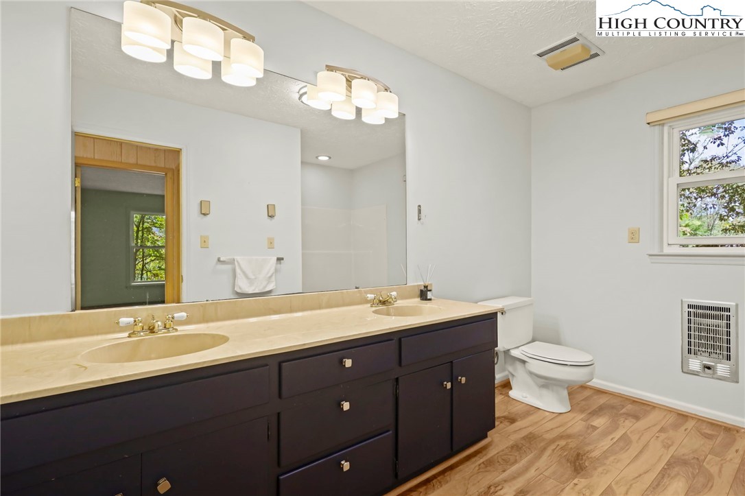 202 Cliffside Lane Seven Devils, NC 28604 - Photo 35 of 46 a bathroom with a double vanity sink and a toilet