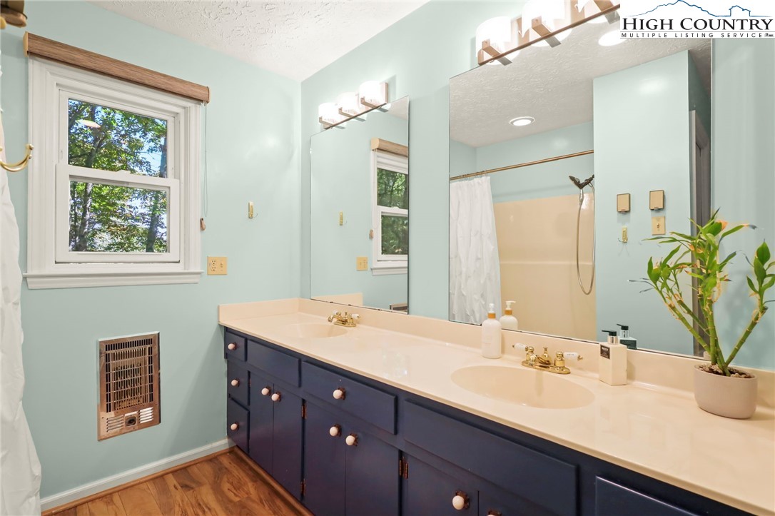 202 Cliffside Lane Seven Devils, NC 28604 - Photo 36 of 46 a bathroom with a sink and a mirror