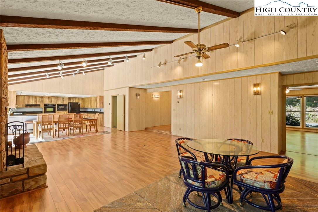 202 Cliffside Lane Seven Devils, NC 28604 - Photo 4 of 46 a view of a dining room with furniture wooden floor and a chandelier