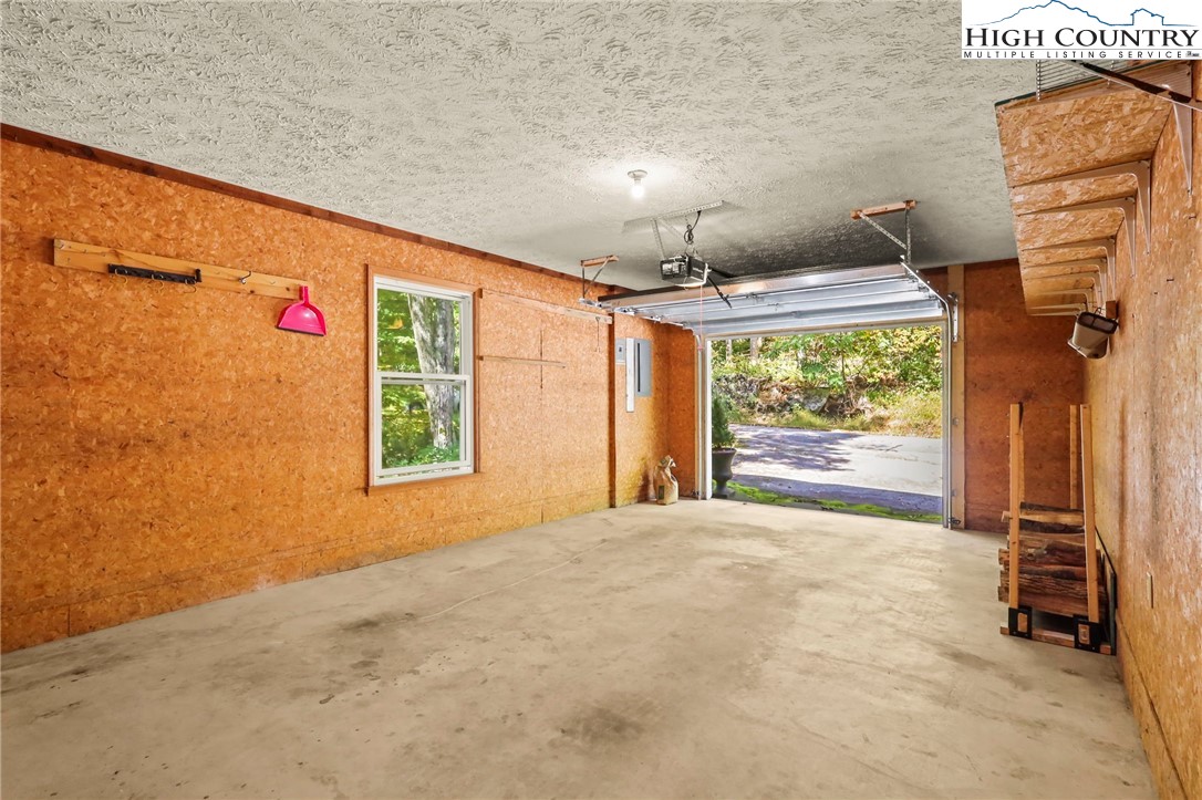 202 Cliffside Lane Seven Devils, NC 28604 - Photo 44 of 46 a view of an empty room with a fireplace and a window