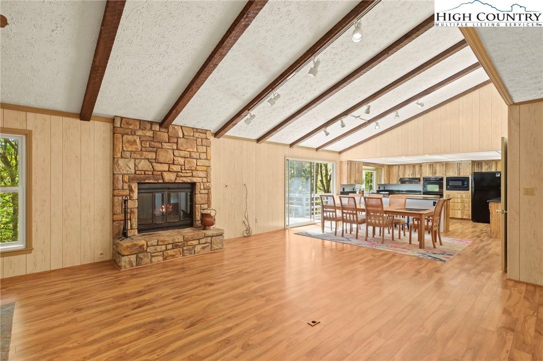 202 Cliffside Lane Seven Devils, NC 28604 - Photo 7 of 46 a view of an empty room with wooden floor and a window