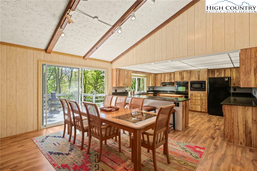 202 Cliffside Lane Seven Devils, NC 28604 - Photo 9 of 46 a view of a dining room with furniture window and outside view