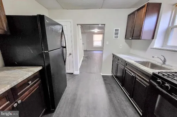 a kitchen with a refrigerator and a sink