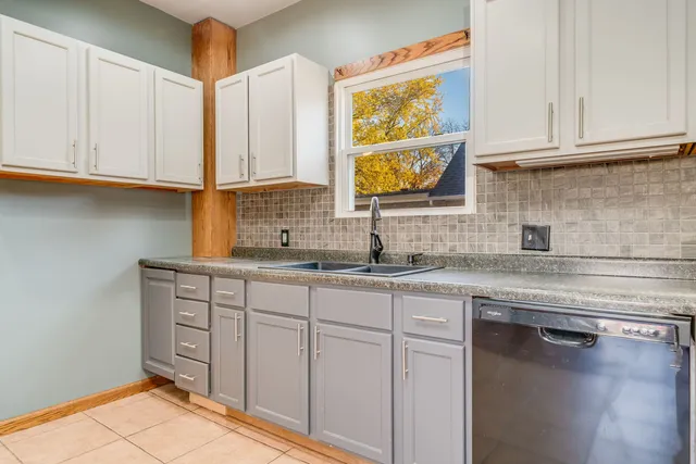 a kitchen with stainless steel appliances granite countertop a sink and cabinets
