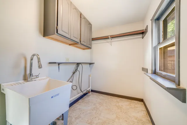 a view of a kitchen with a sink and windows