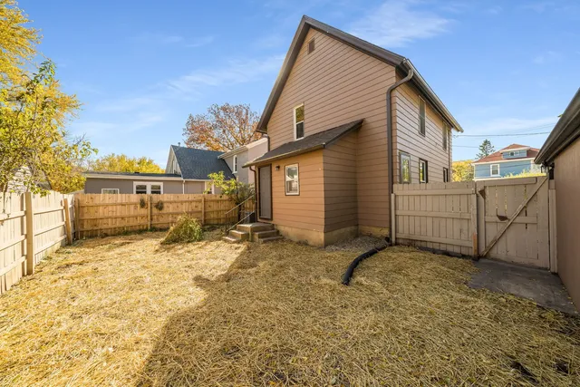 a view of house with a yard and garage