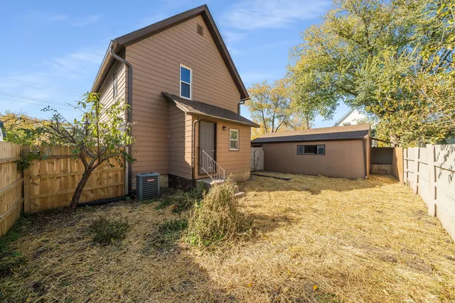 a view of wooden house with a bench