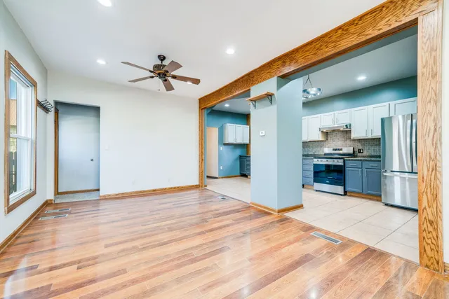 a view of a kitchen with refrigerator and windows