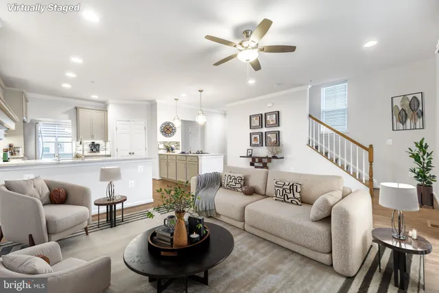 a living room with furniture and kitchen view