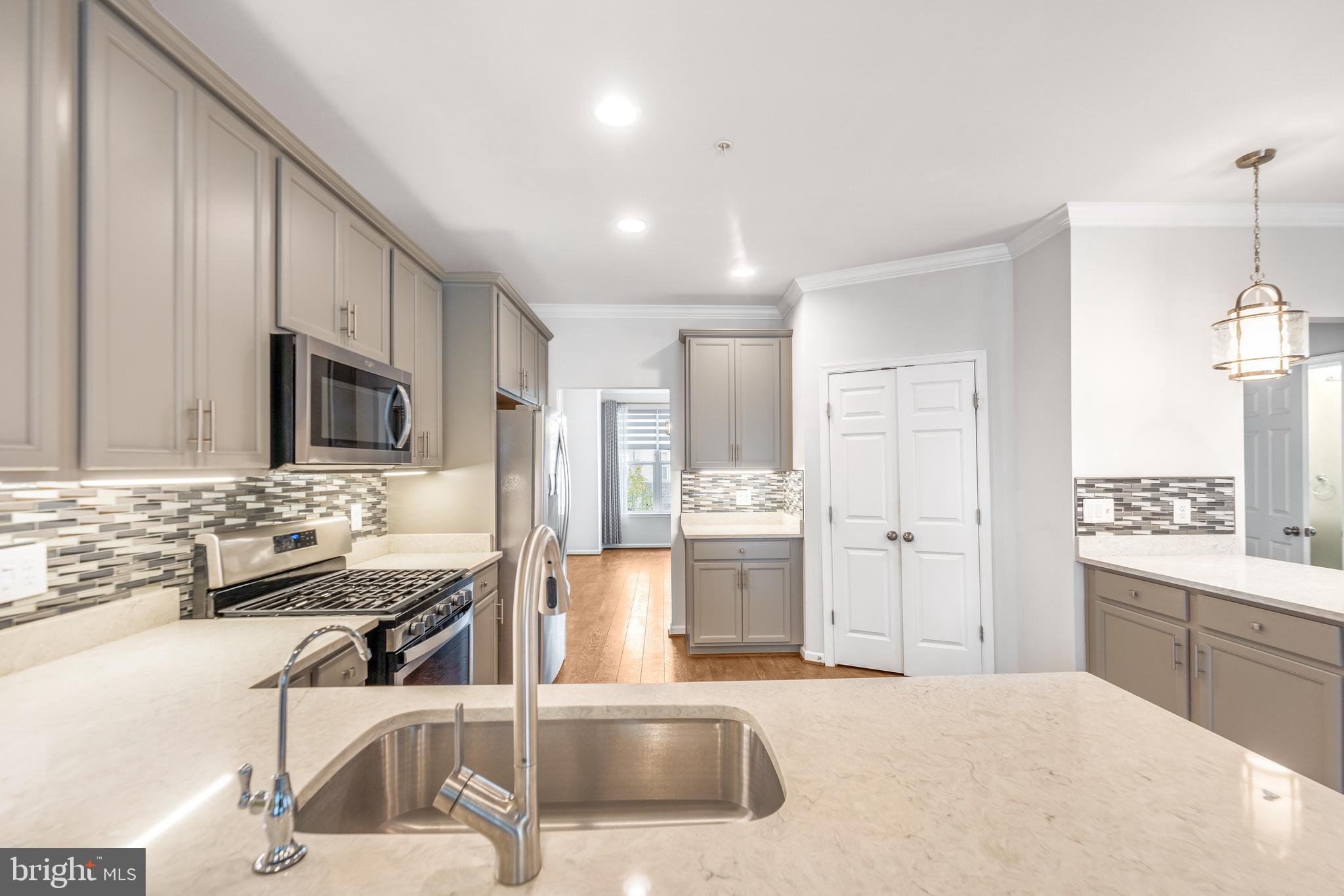 3510 Landing Way Silver Spring, MD 20906 - Photo 16 of 47 a kitchen with stainless steel appliances kitchen island granite countertop a sink refrigerator and cabinets