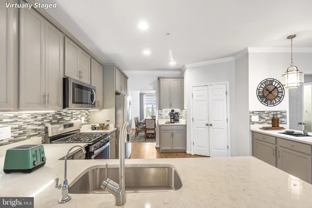 a kitchen with stainless steel appliances kitchen island granite countertop a sink and cabinets