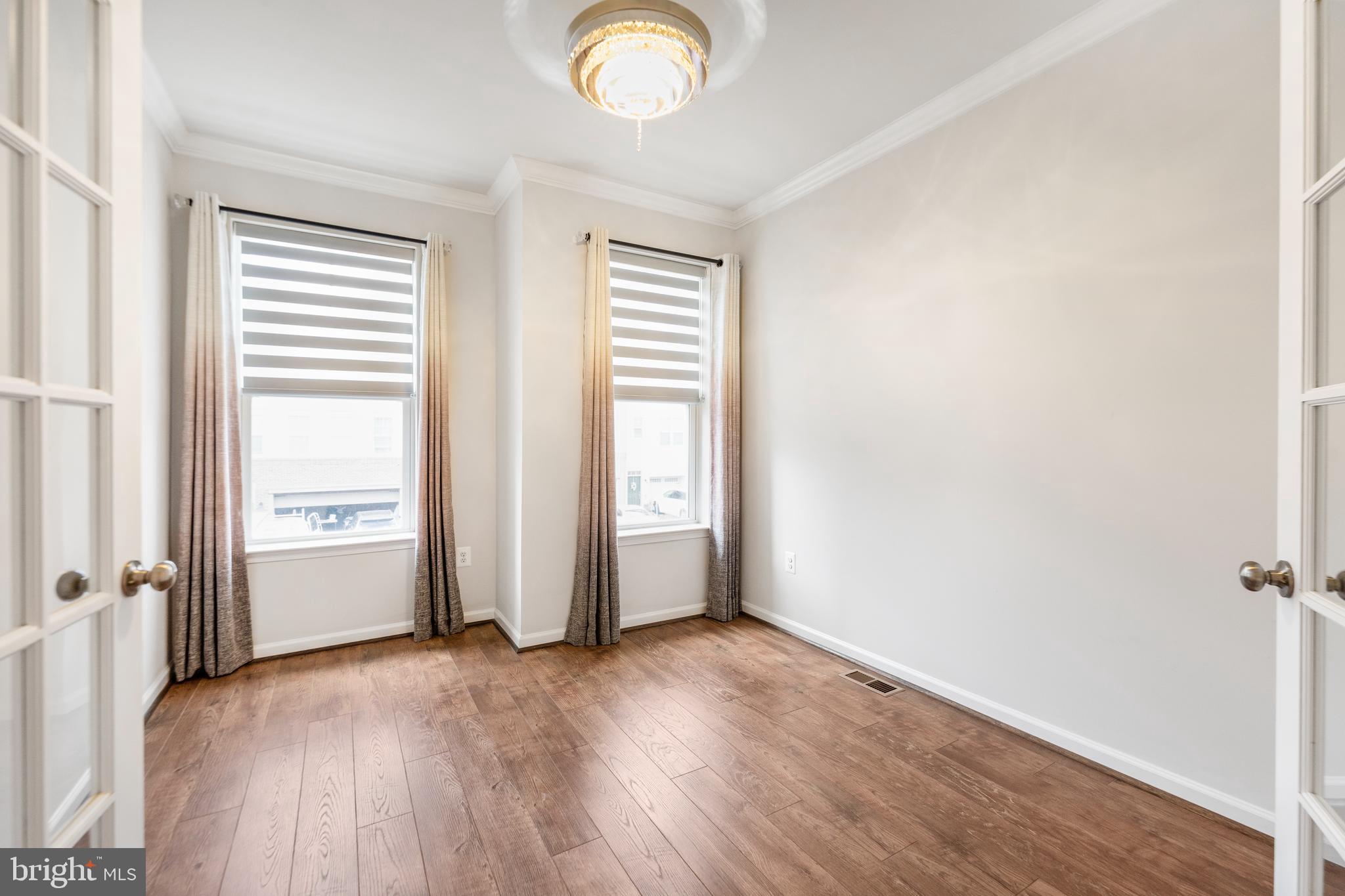 3510 Landing Way Silver Spring, MD 20906 - Photo 20 of 47 an empty room with wooden floor and windows