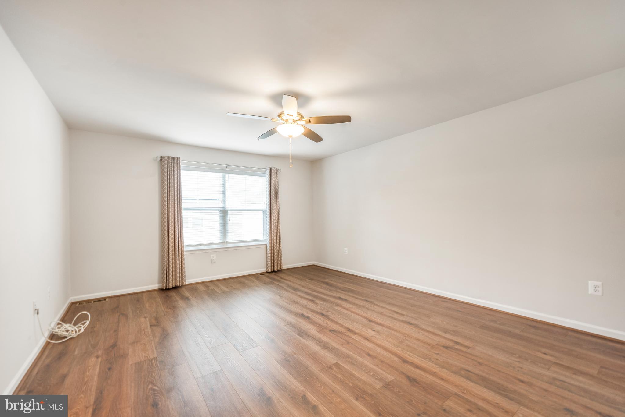 3510 Landing Way Silver Spring, MD 20906 - Photo 24 of 47 an empty room with wooden floor and windows