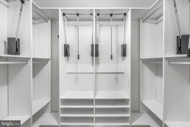 a bathroom with a double vanity sink toilet mirror and shower