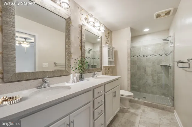 a bathroom with a double vanity sink mirror and bathtub