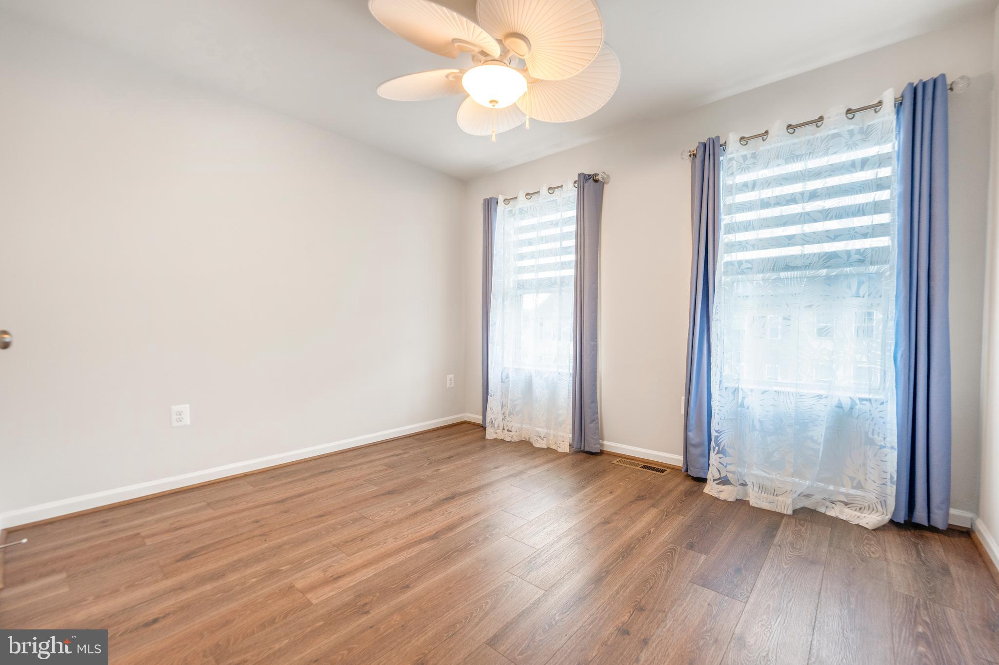 3510 Landing Way Silver Spring, MD 20906 - Photo 32 of 47 an empty room with wooden floor and windows
