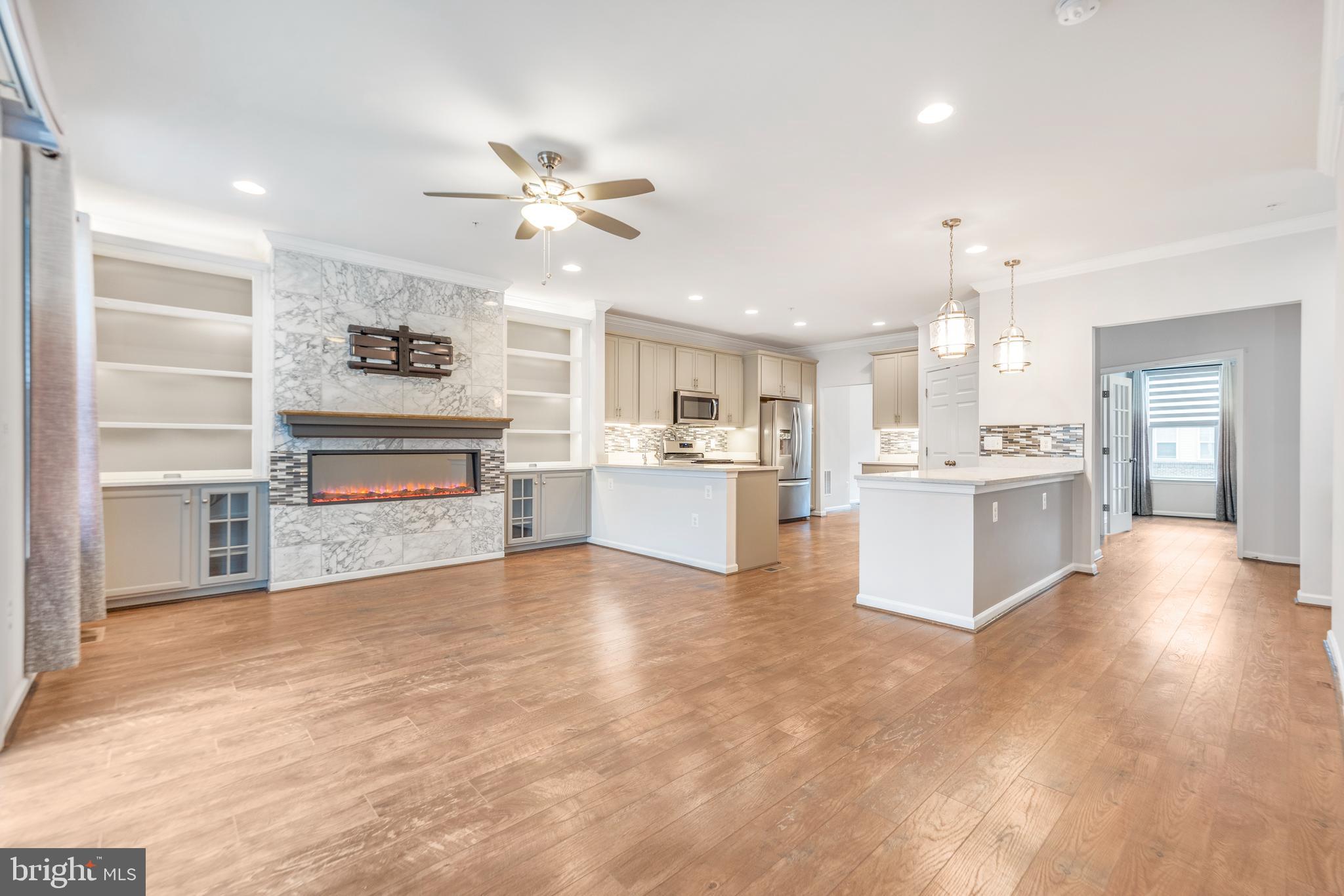 3510 Landing Way Silver Spring, MD 20906 - Photo 10 of 47 a view of kitchen with kitchen island a stove a sink dishwasher and white cabinets with wooden floor