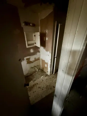 a view of a room with wooden walls