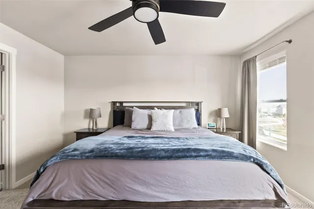 a bed sitting in a bedroom next to a window