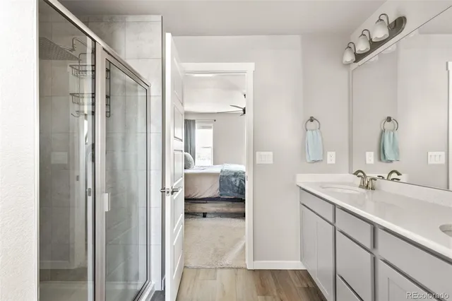 a en suite bathroom with a sink a mirror and a shower