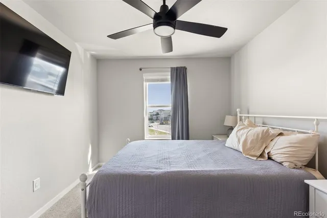 a bedroom with a large bed and a tv