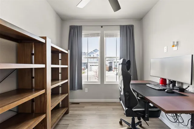 a view of a workspace with furniture and a window