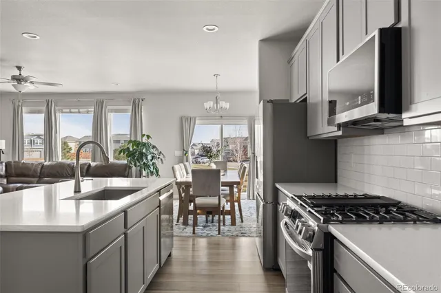 a kitchen with granite countertop a sink stove and cabinets