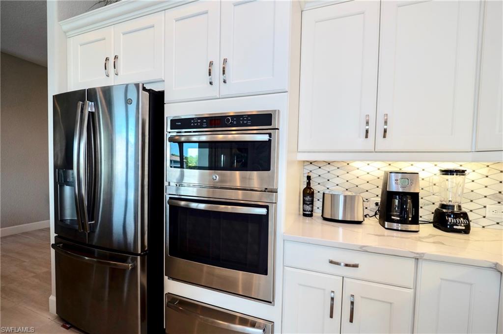 8008 Signature Club Circle Naples, FL 34113 - Photo 15 of 30 a kitchen with refrigerator and cabinets