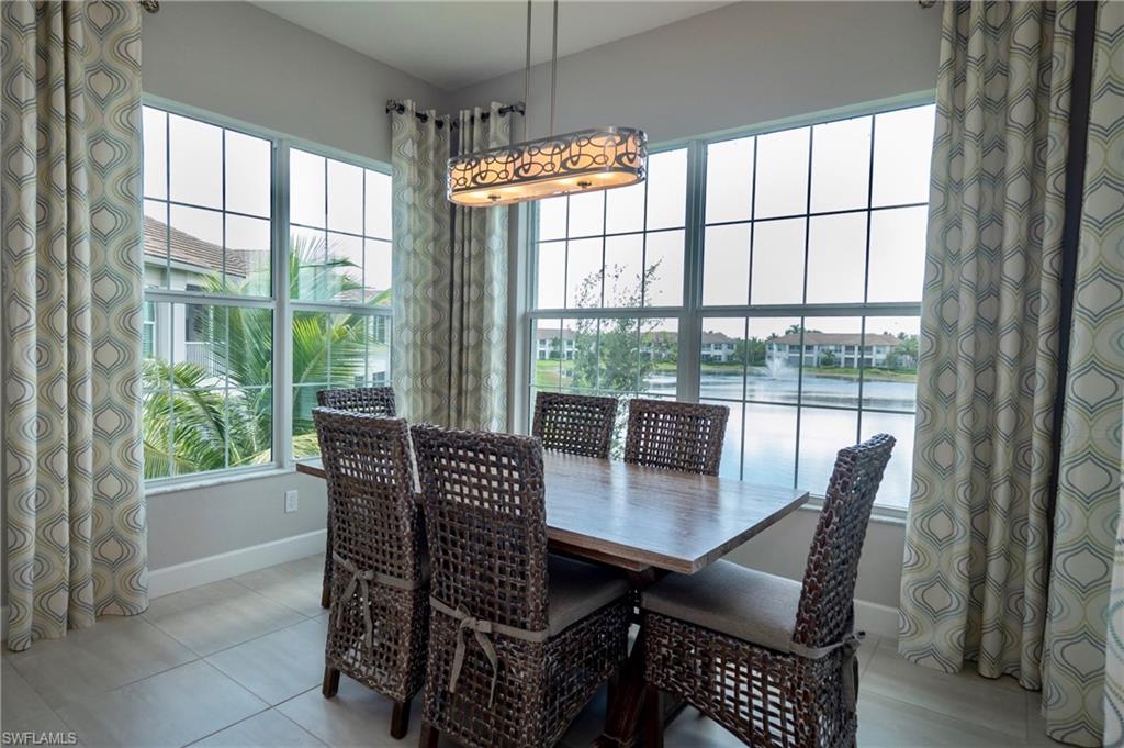 8008 Signature Club Circle Naples, FL 34113 - Photo 16 of 30 a view of a dining room with furniture window and wooden floor