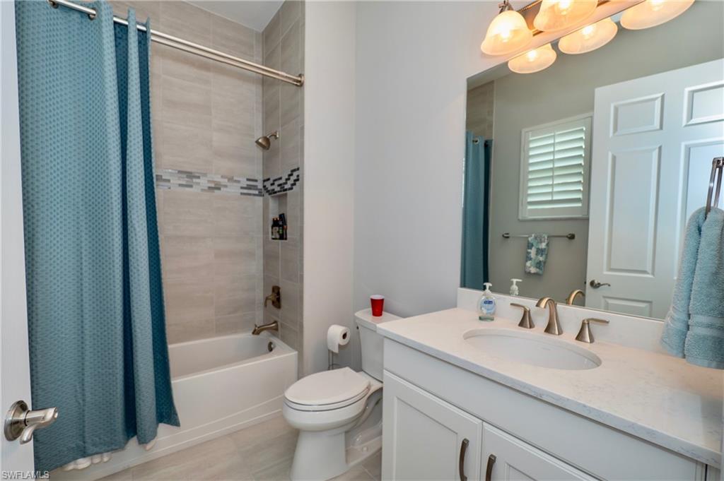 8008 Signature Club Circle Naples, FL 34113 - Photo 25 of 30 a bathroom with a sink a toilet and shower