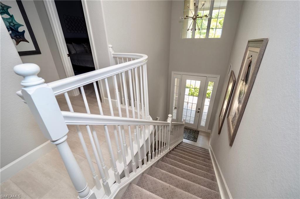 8008 Signature Club Circle Naples, FL 34113 - Photo 5 of 30 a view of staircase with railing and a floor to ceiling window