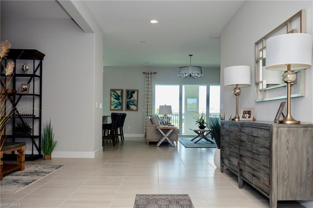 8008 Signature Club Circle Naples, FL 34113 - Photo 6 of 30 a living room with furniture window and wooden floor