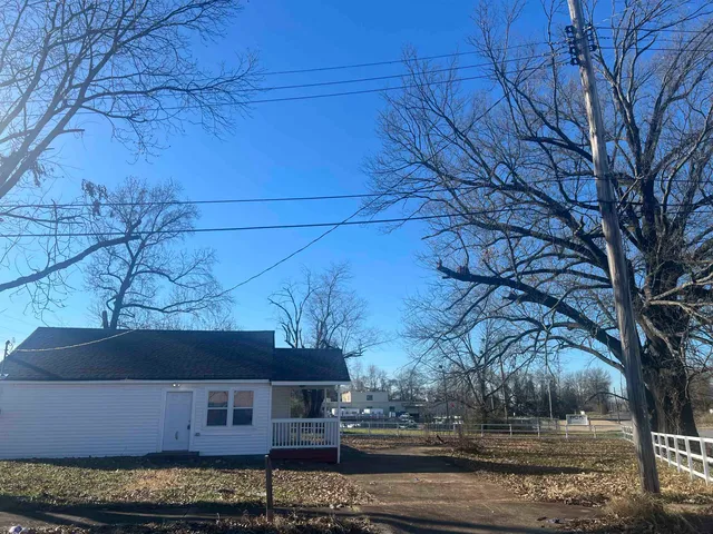 a front view of a house with trees