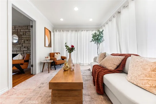 a living room with furniture and a potted plant