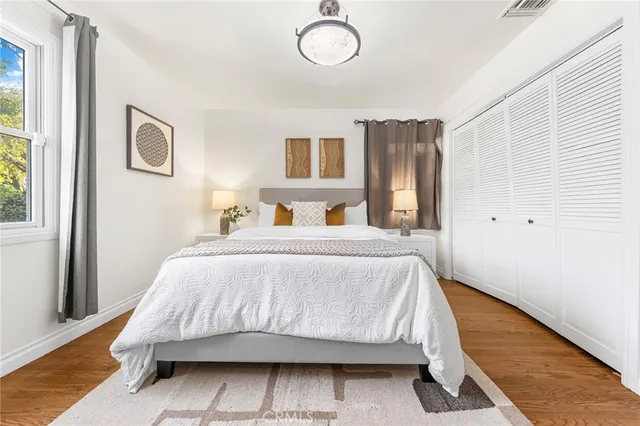 a bedroom with a bed and window