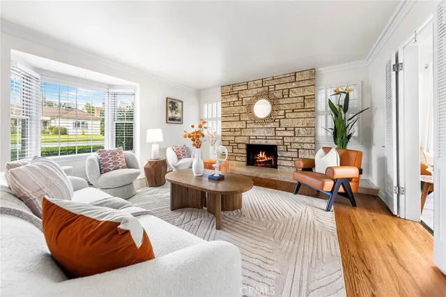 a living room with furniture fireplace and a large window